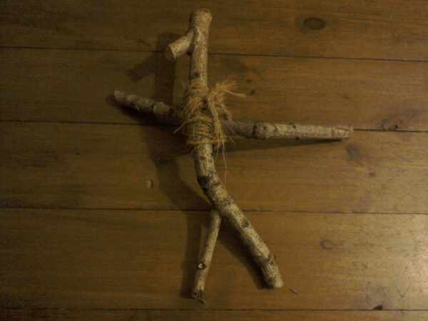 Doll made with wooden sticks tied together