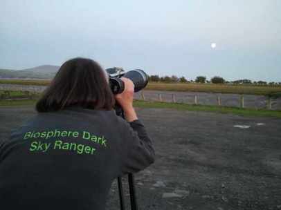 Biosphere Dark Sky Ranger using astronomy binoculars to look at the moon