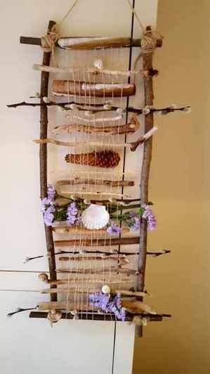 A wall hanging made with drift wood and shells