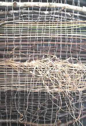 the detail of a weaving showing greens and browns