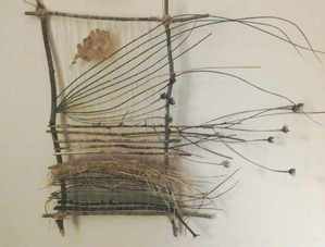 Nature weaving with reeds and an oak leaf